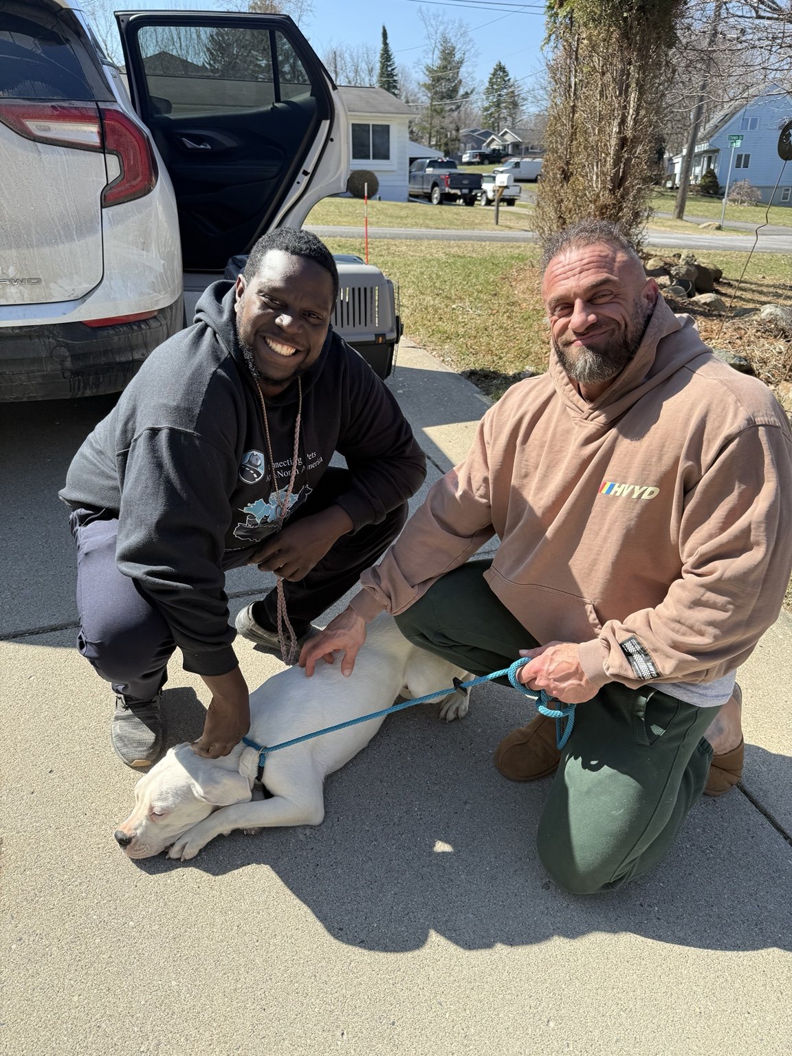 Nigel with a client and dog during a daytime delivery